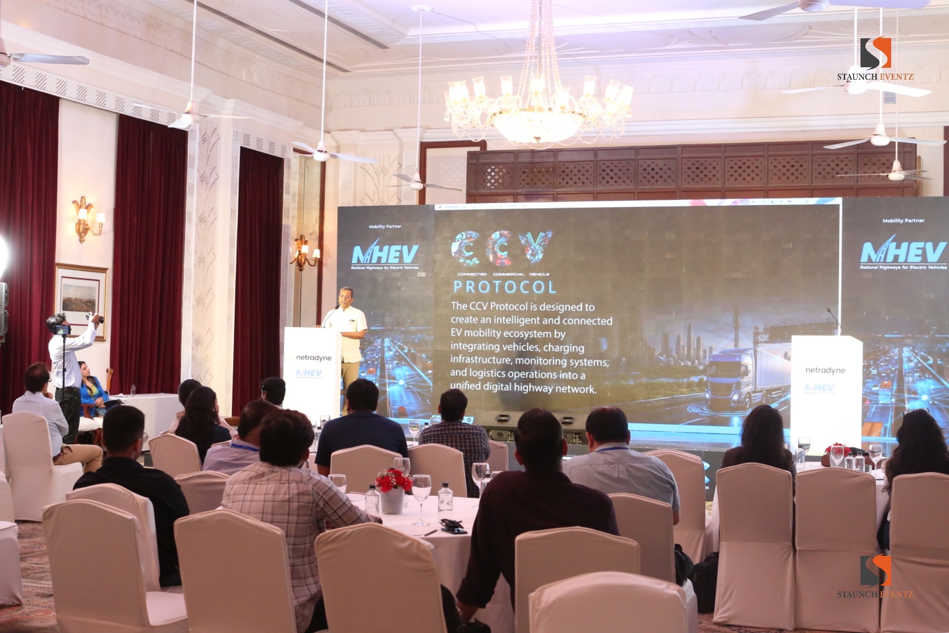 Conference delegates seated at tables facing a presentation screen in Staunch Eventz’s Netradyne gallery
